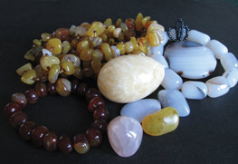 various colors of chalcedony tumbled stones and necklaces